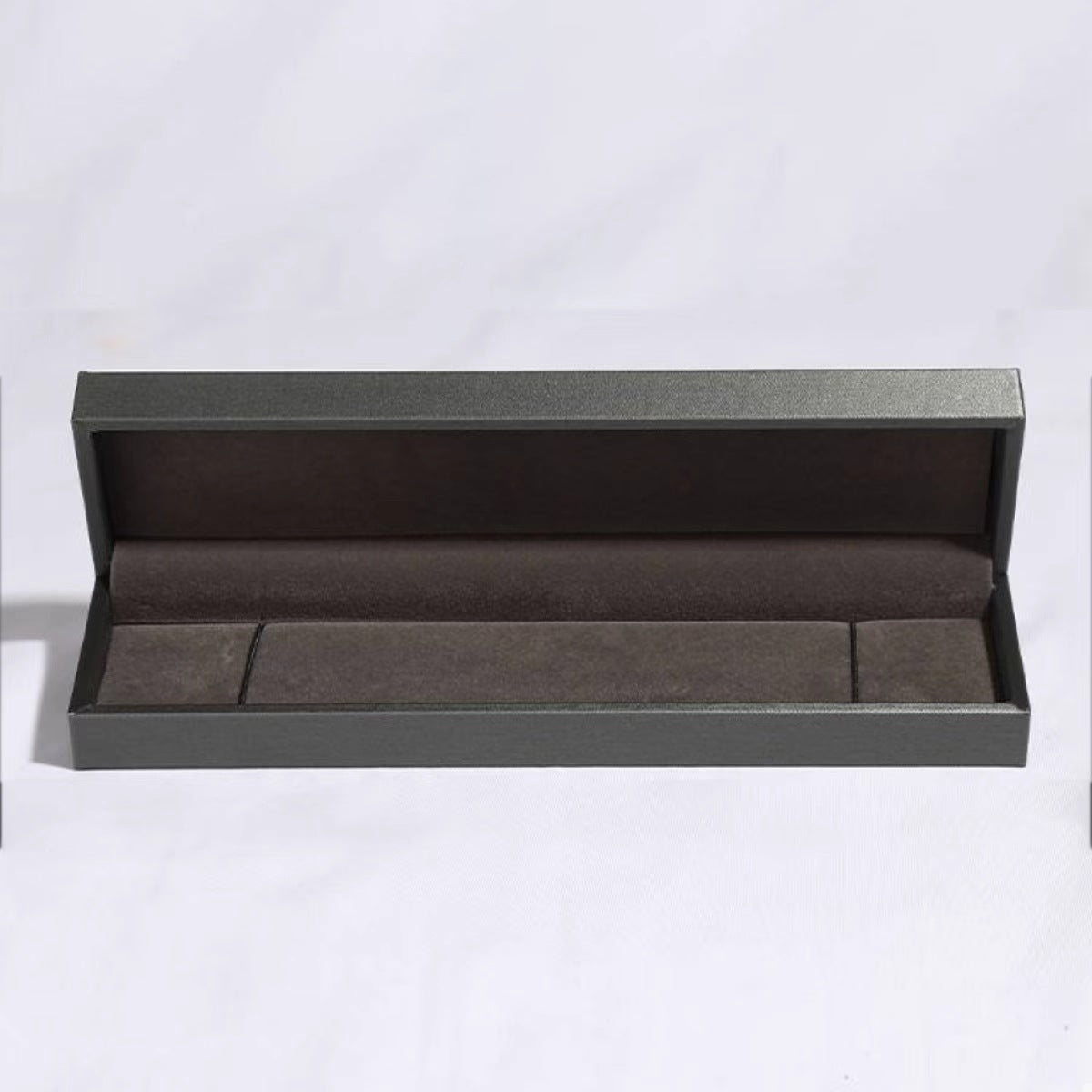 Open gray jewelry box on a white background