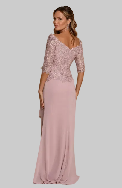 A woman modeling a floor-length formal gown with a dusty pink satin skirt and a heavily embellished lace bodice, photographed against a warm tan studio backdrop. BY KONFIDENTIAL KOUTURE