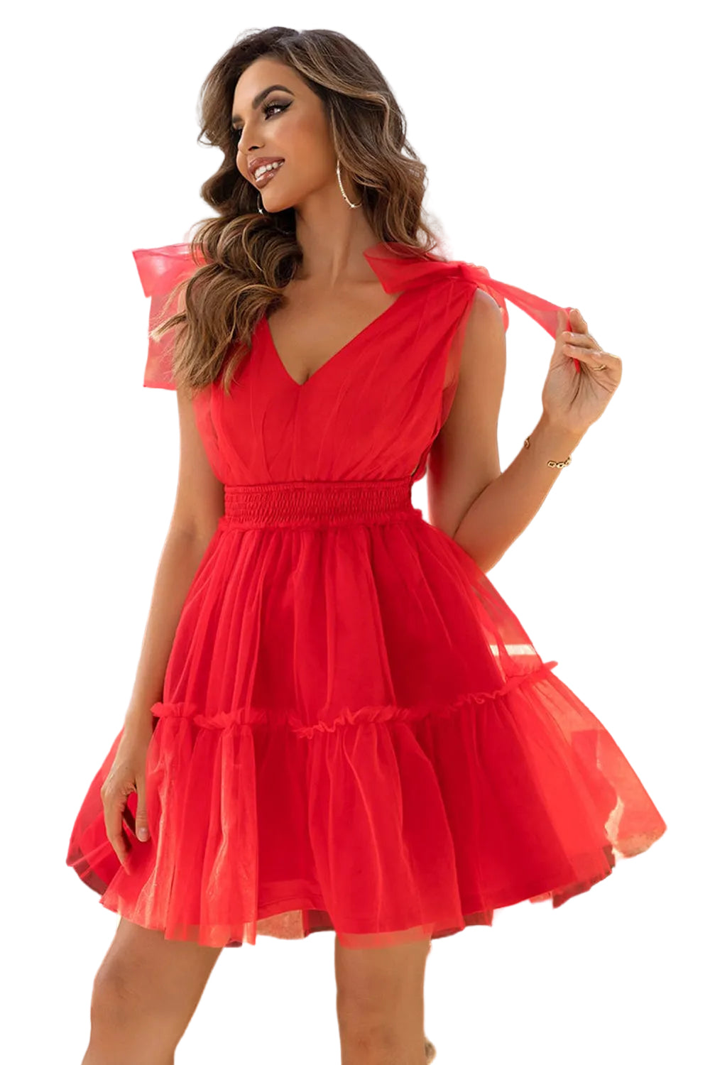 Woman wearing a red dress standing outdoors with trees in the background