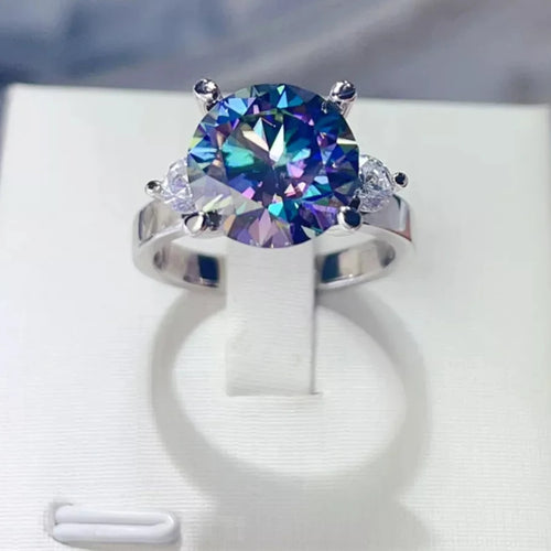 5ct blue moissanite diamond Ring with a colorful gemstone on a white stand